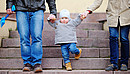 outdoors, girl, people, person, young, park, love, parent, father, family, mother, lifestyle, woman, day, man, boy, city, town, urban, support, happy, holding, hands, walking, child, steps, stairs, aged, playing, development, little, foot, son, european, jeans, three, kid, baby, together, parenting, parenthood, legs, offspring, toddler, cone, grandson, teaching, grandparents, stride, going