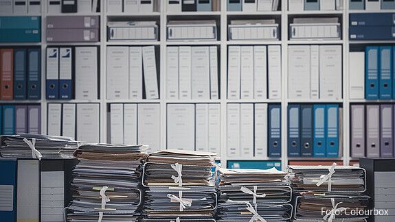 Das Foto zeigt eine Wand voll mit Aktenordnern.